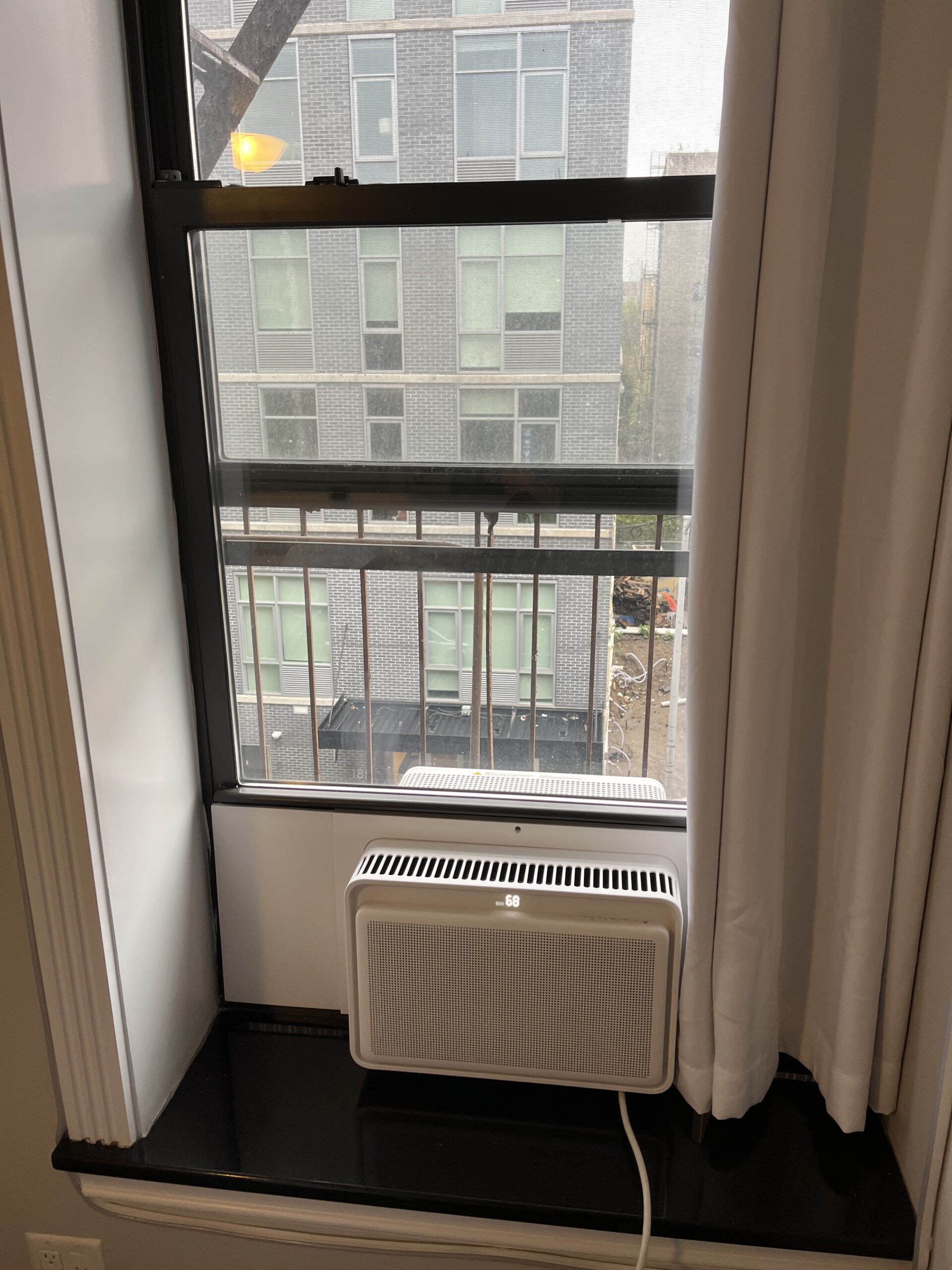 Modern Windmill-style window AC installation