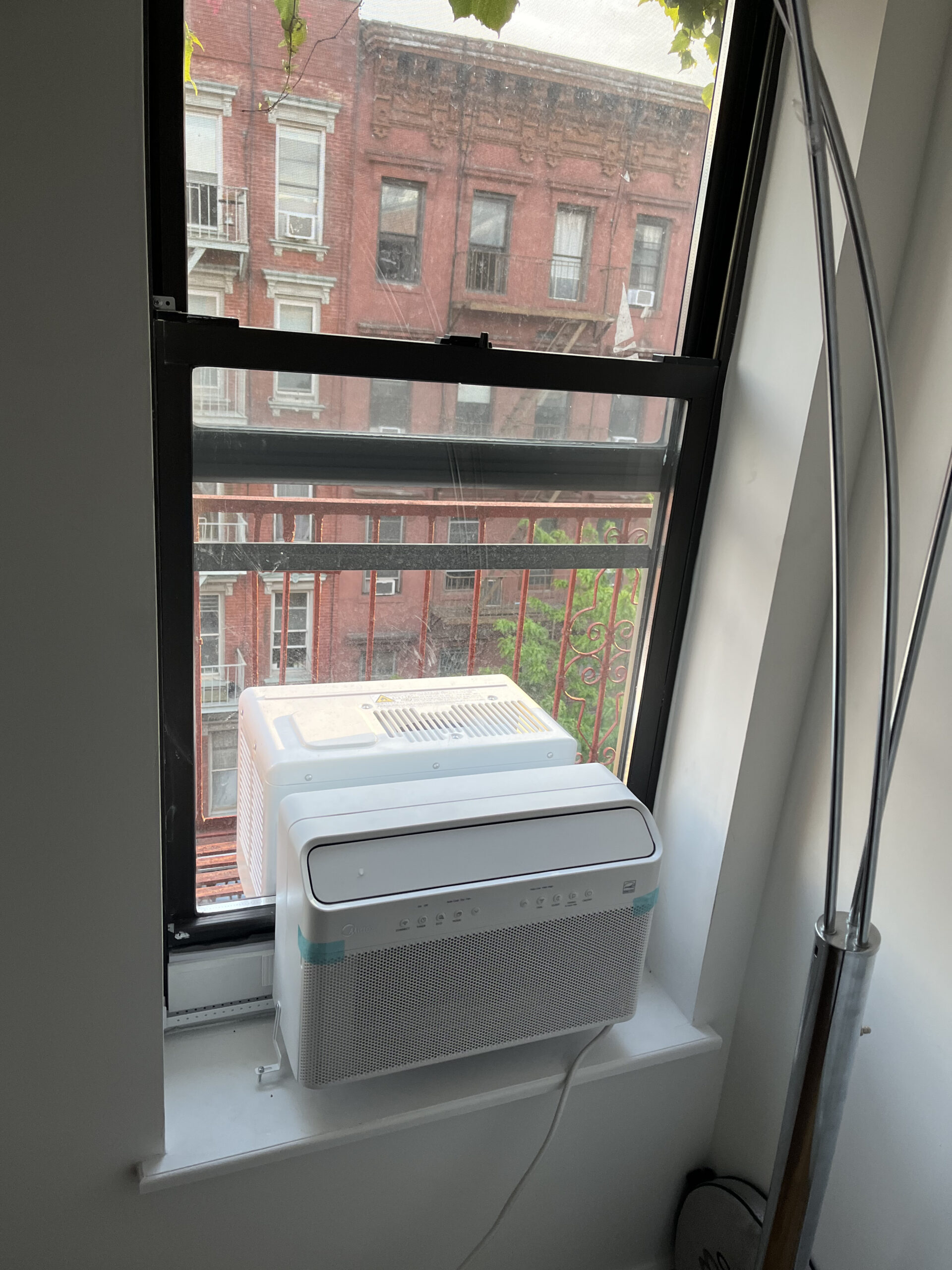 Window-mounted air conditioner during summer