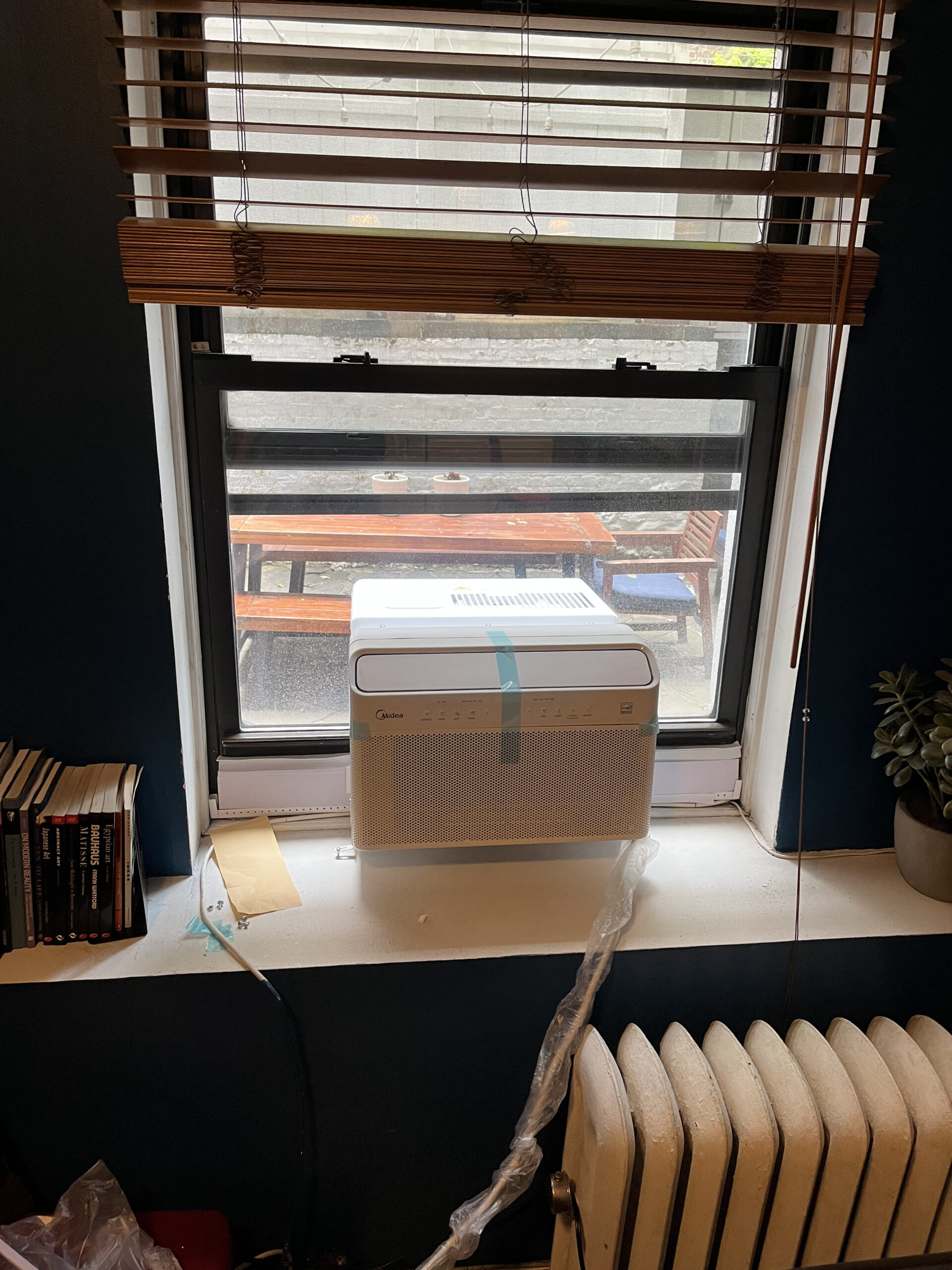 Expert installer fitting AC into window frame