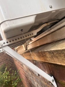 Window air conditioner leaking water in NYC apartment due to improper installation and clogged drainage